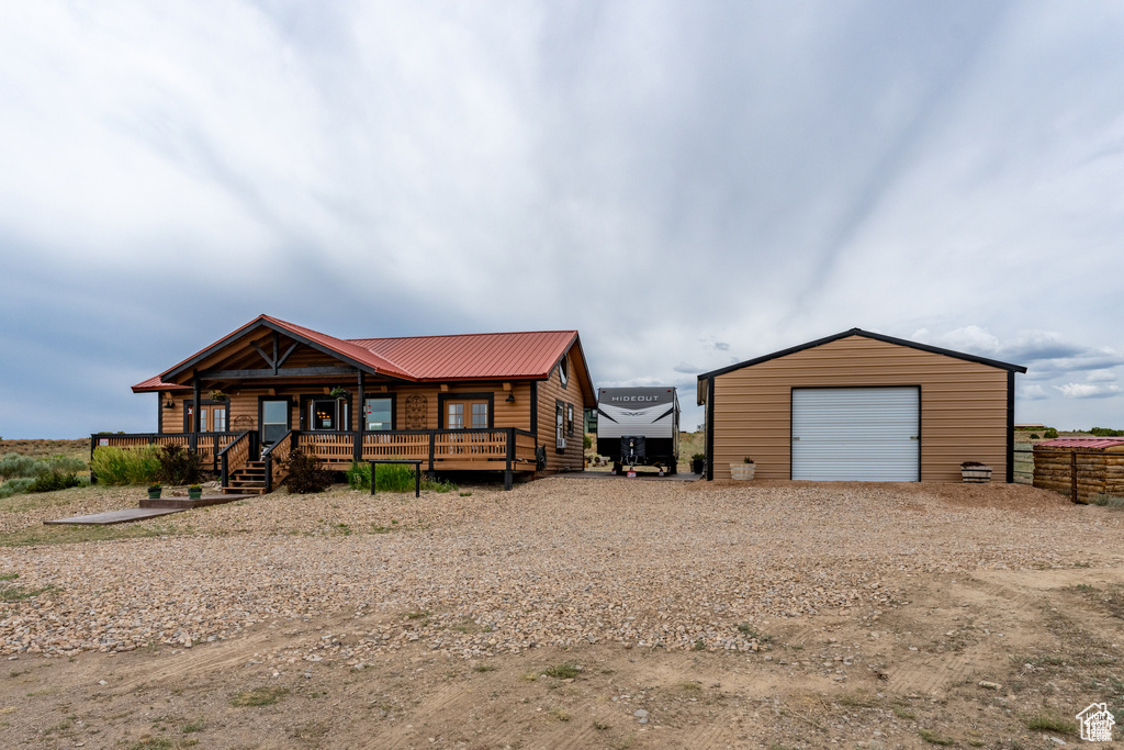 View of front facade with a garage and an outbuilding