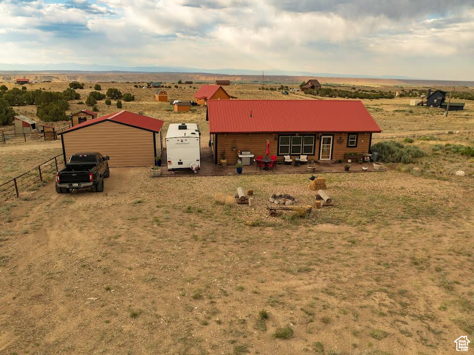 Ranch-style house featuring a rural view and an outdoor structure