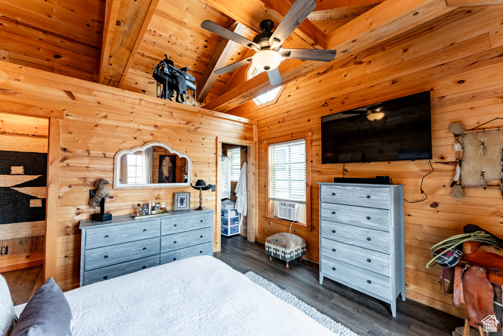 Bedroom with dark hardwood / wood-style flooring, wood ceiling, ceiling fan, wood walls, and lofted ceiling with beams