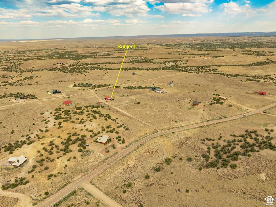 Birds eye view of property with a rural view