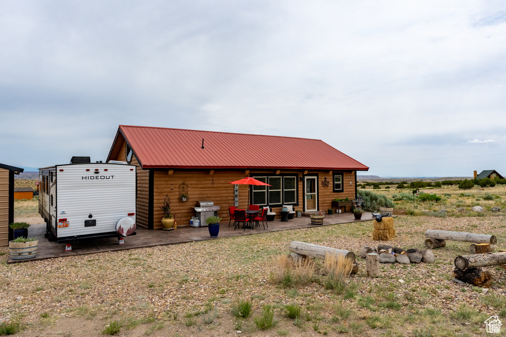 Rear view of property featuring a patio and a storage shed