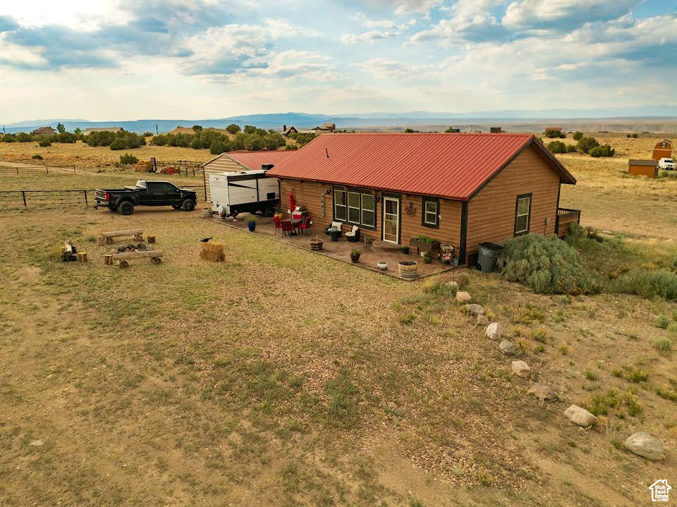 Rear view of house featuring a rural view