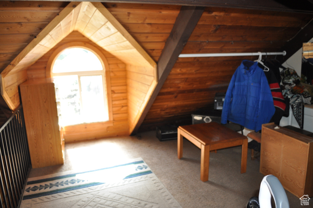 Bonus room featuring rustic walls