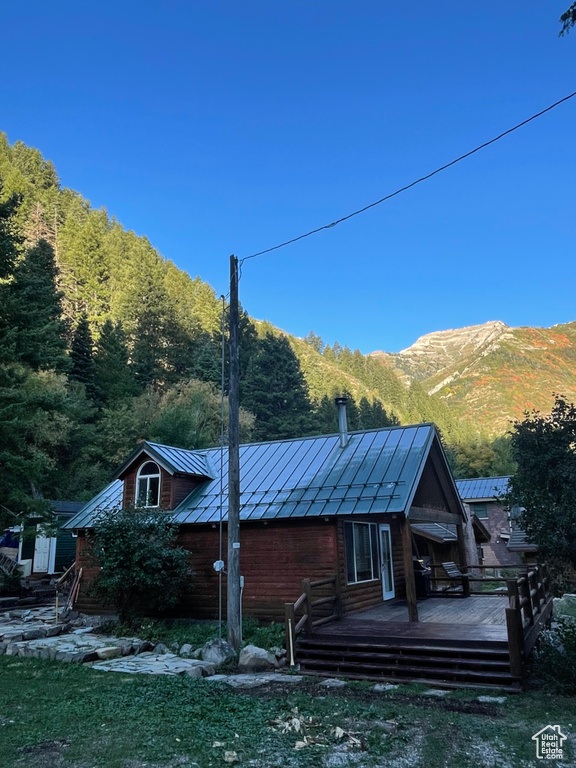 Rear view of property with a deck with mountain view