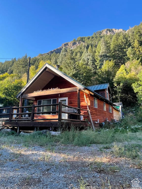 View of side of property featuring a deck with mountain view