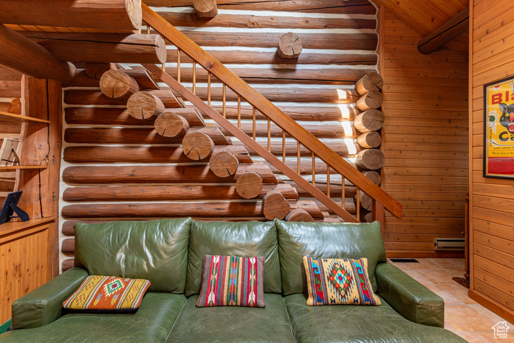 Interior space with wooden ceiling, wooden walls, and light tile patterned floors