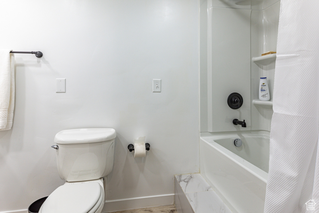 Bathroom with shower / bath combo and toilet