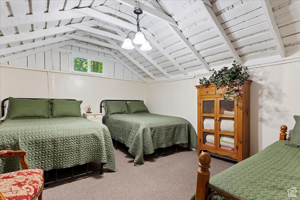 Carpeted bedroom with lofted ceiling