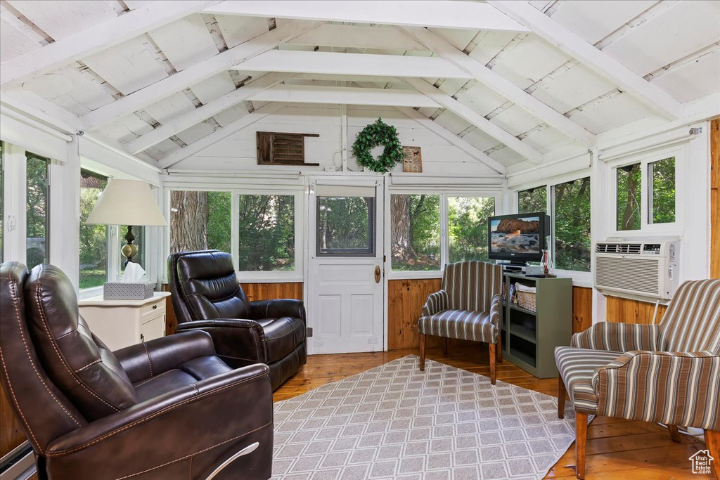 Sunroom with vaulted ceiling with beams, cooling unit, and a healthy amount of sunlight