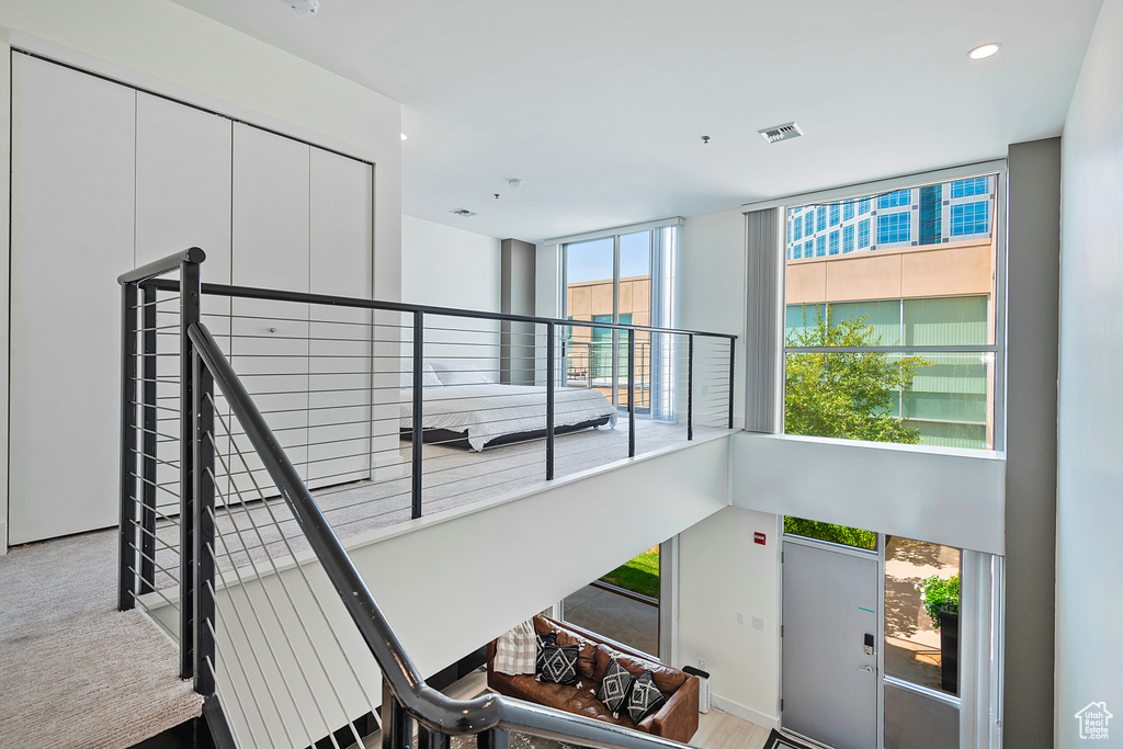 Stairs with carpet floors and a wealth of natural light