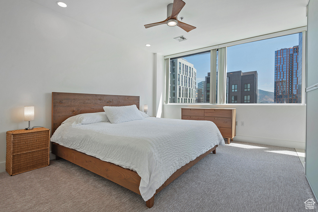 Bedroom featuring light carpet and ceiling fan