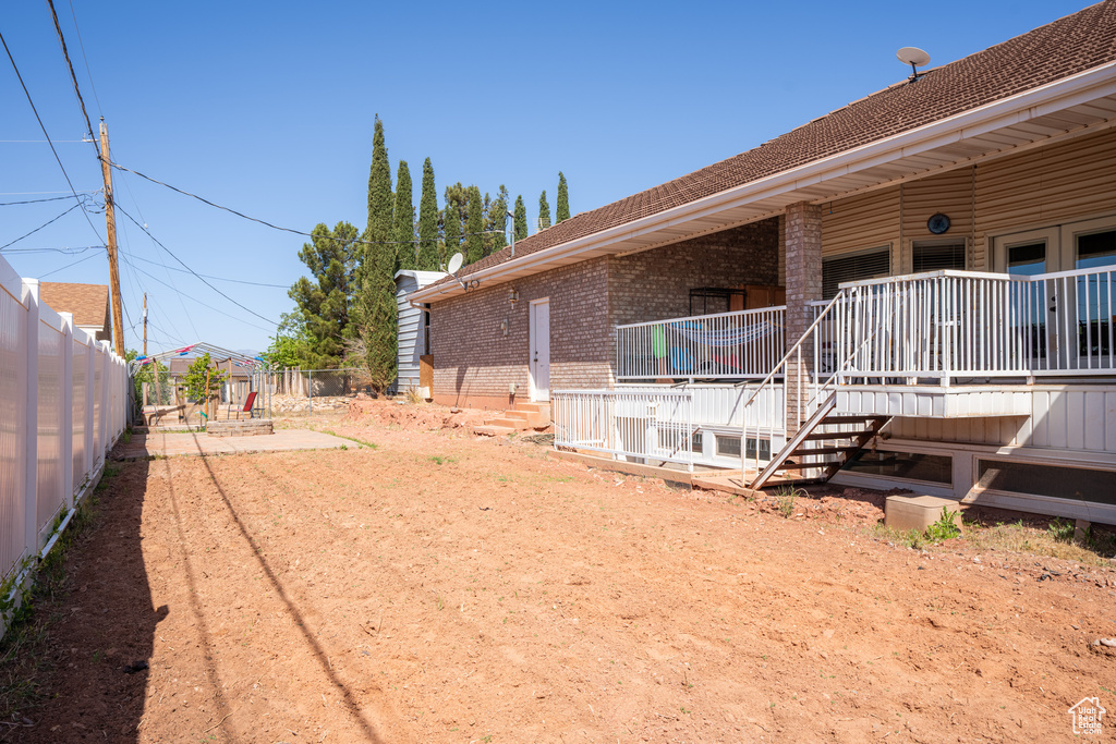 View of yard with a wooden deck