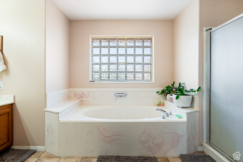 Bathroom with vanity, plus walk in shower, and tile patterned flooring