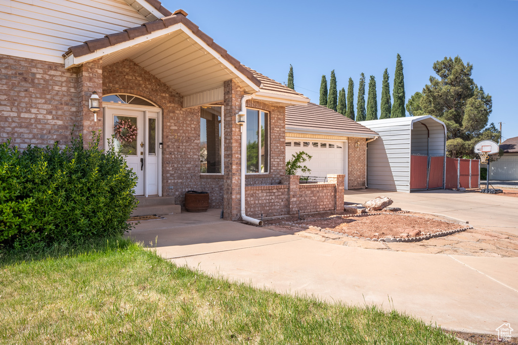 View of front of house with a carport and a garage