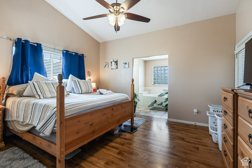 Bedroom featuring ceiling fan, vaulted ceiling, and dark hardwood / wood-style floors