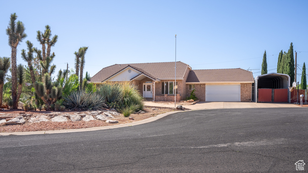 View of front of home with a carport and a garage