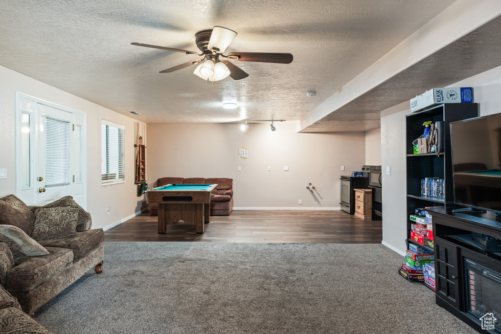 Rec room featuring a textured ceiling, pool table, hardwood / wood-style floors, and ceiling fan