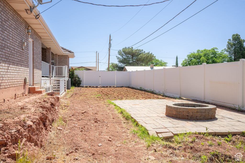 View of yard featuring a patio and an outdoor fire pit