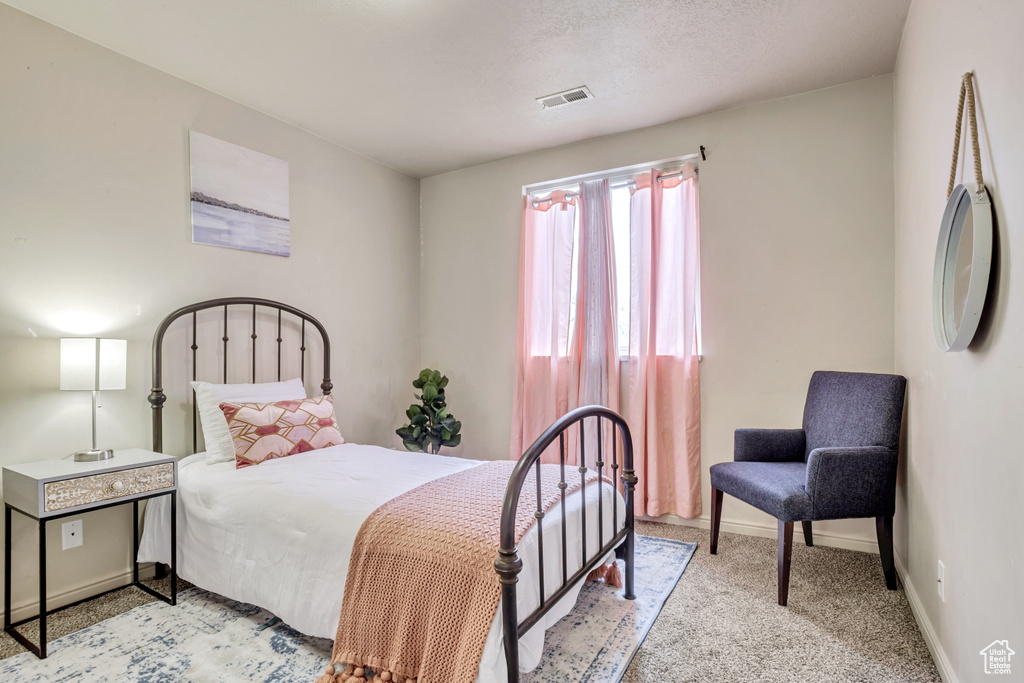 Bedroom with light colored carpet