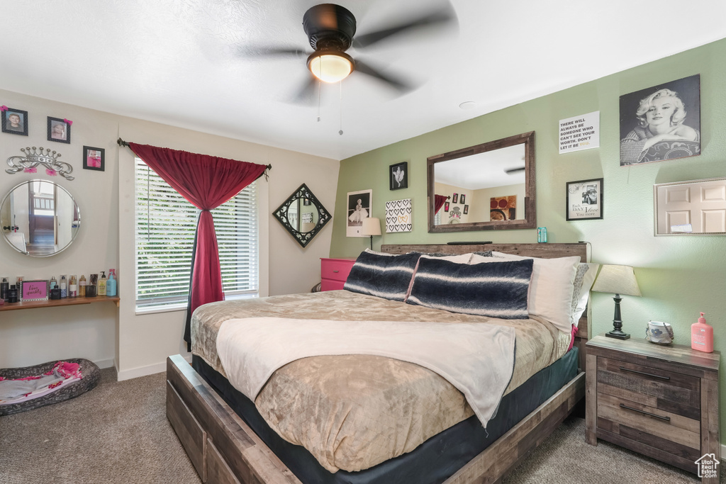 Carpeted bedroom with ceiling fan