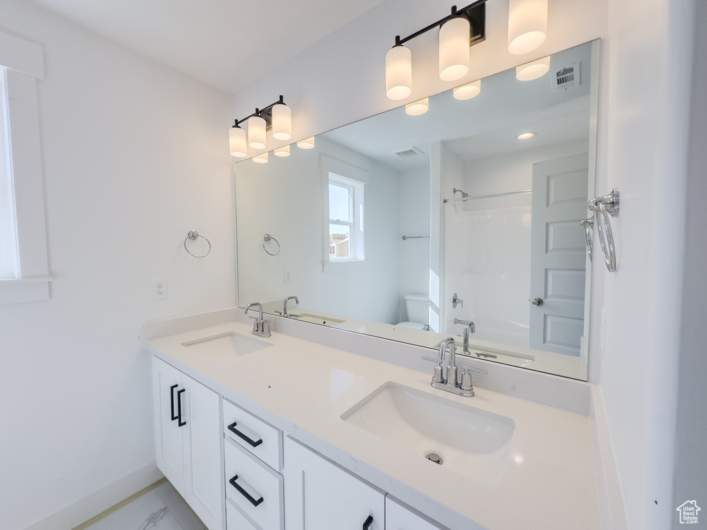 Full bathroom with shower / washtub combination, vanity, and toilet