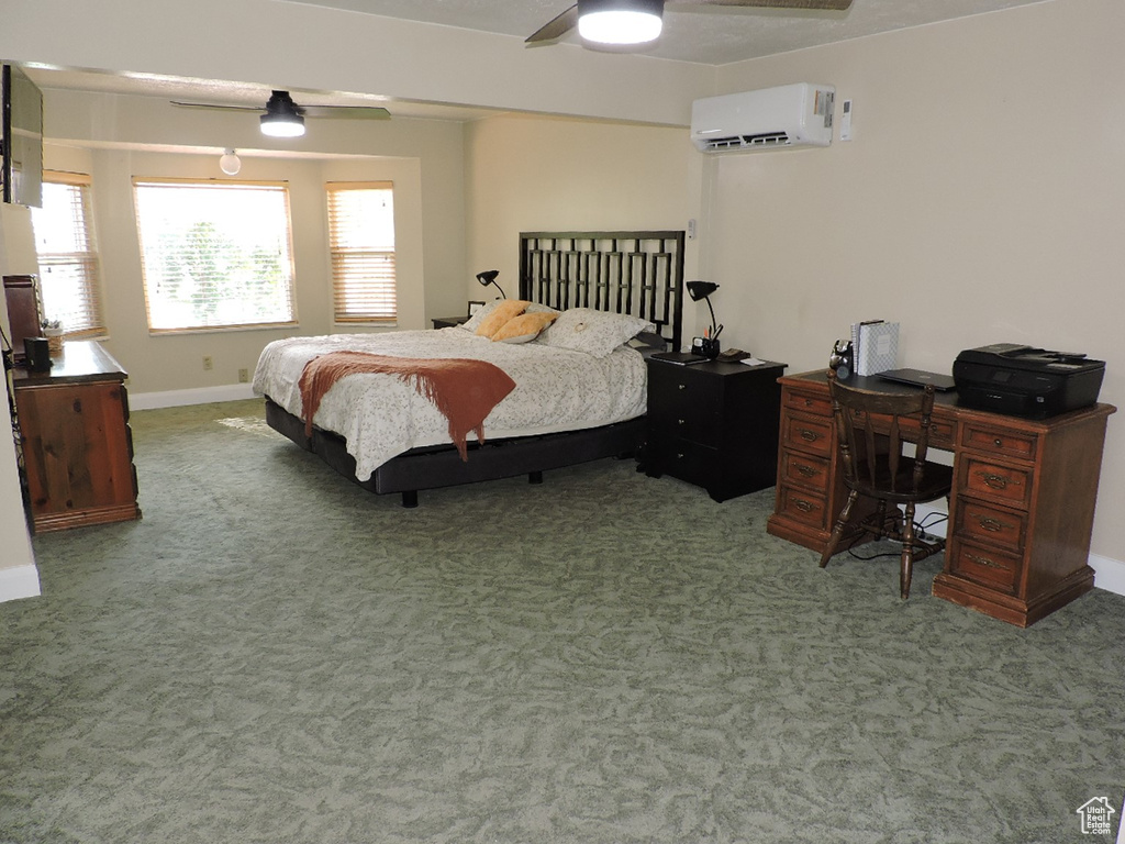 Bedroom featuring ceiling fan, carpet flooring, and a wall unit AC