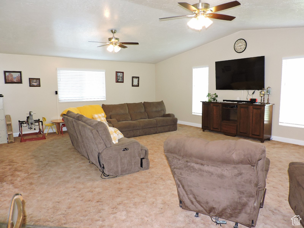 Living room featuring ceiling fan and light carpet