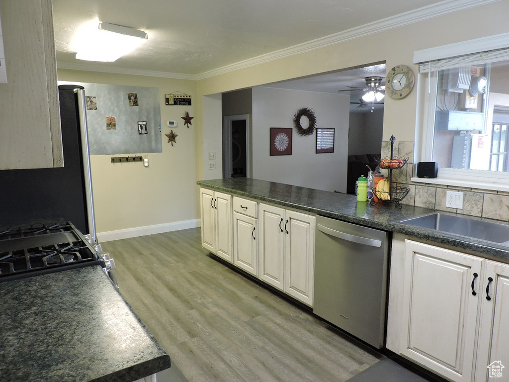 Kitchen with dishwasher, light hardwood / wood-style floors, ornamental molding, ceiling fan, and white cabinets