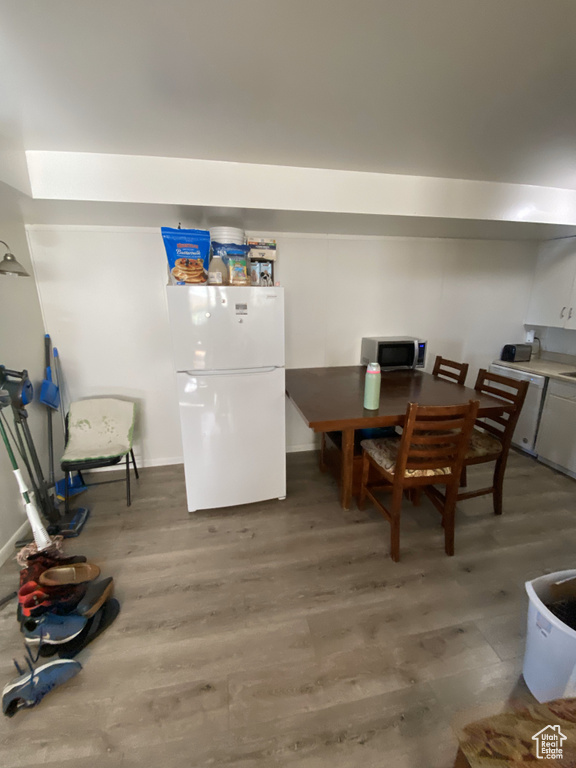 Dining space with hardwood / wood-style floors