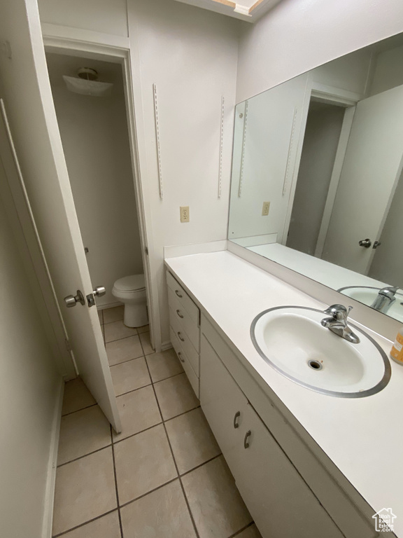 Bathroom with vanity, tile patterned flooring, and toilet