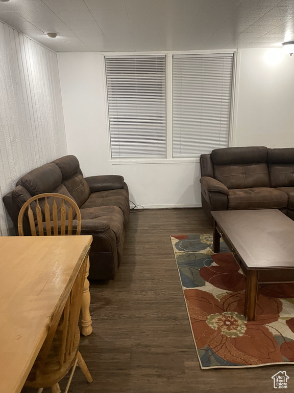 Living room with dark wood-type flooring