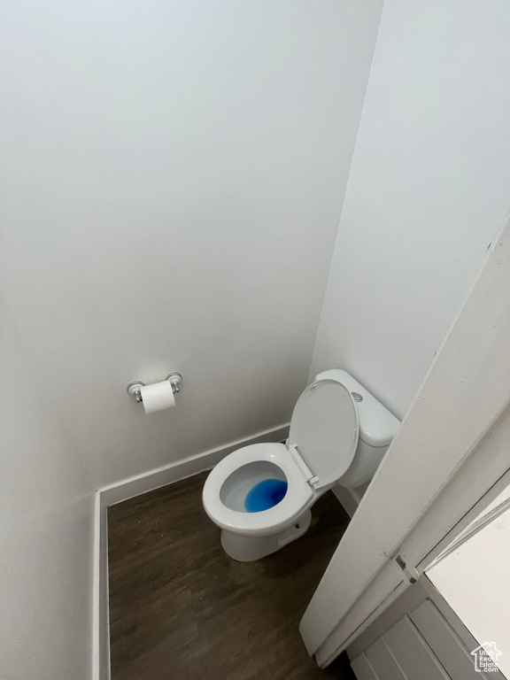 Bathroom with hardwood / wood-style flooring and toilet