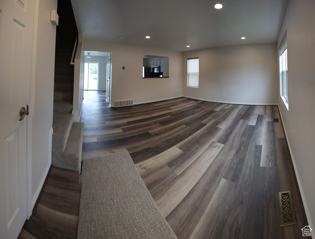 Unfurnished living room featuring dark hardwood / wood-style flooring