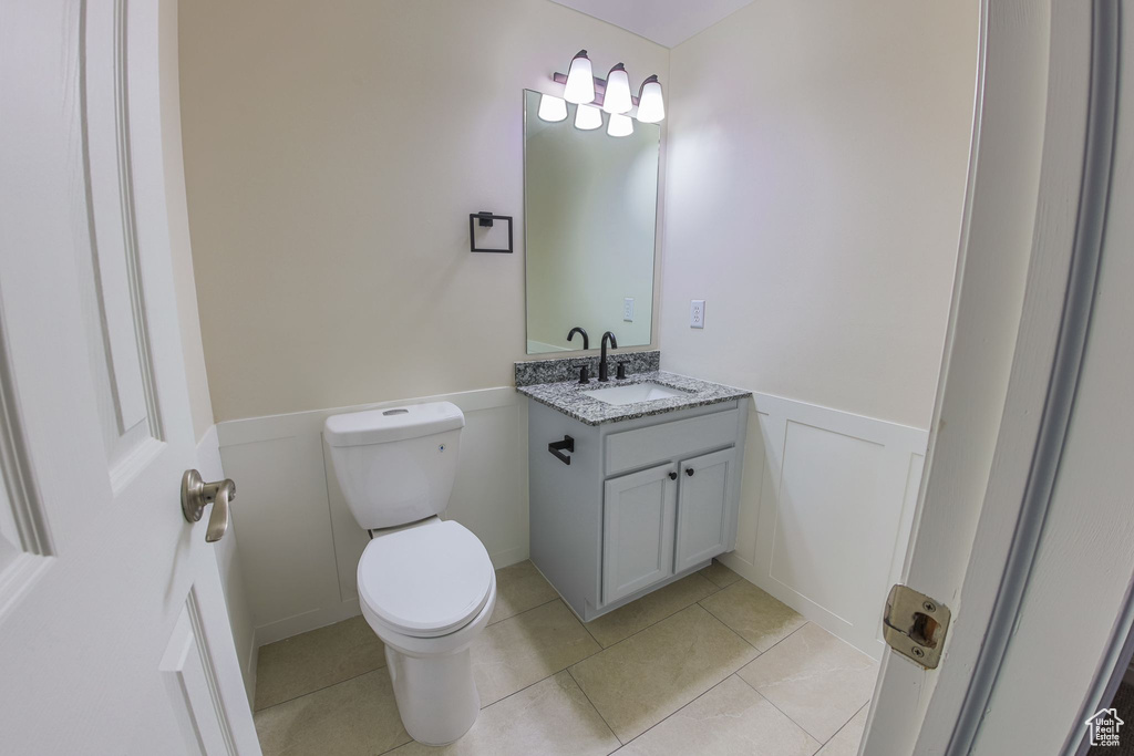 Bathroom featuring tile patterned floors, toilet, and vanity