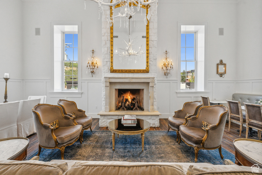 Living room with wood-type flooring, a chandelier, and a healthy amount of sunlight