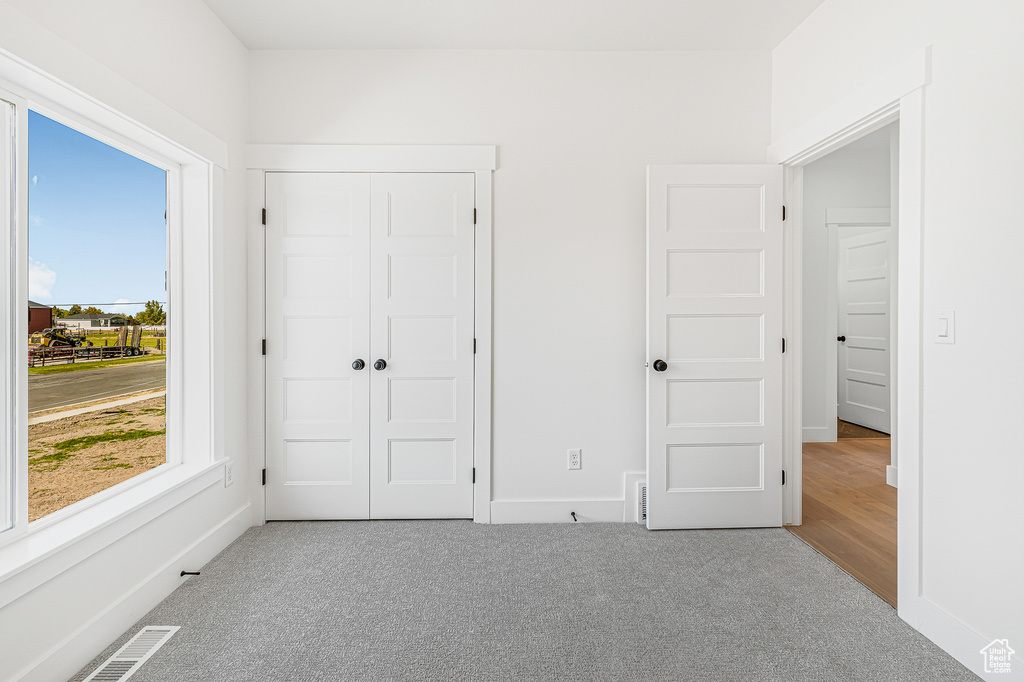 Unfurnished bedroom with a closet and carpet floors