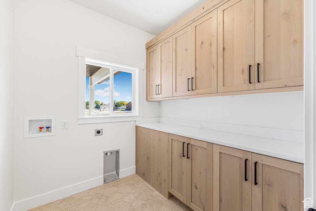 Washroom featuring washer hookup, cabinets, and electric dryer hookup