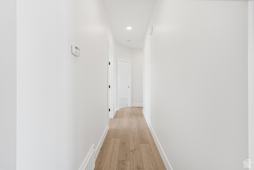 Hall with light hardwood / wood-style floors