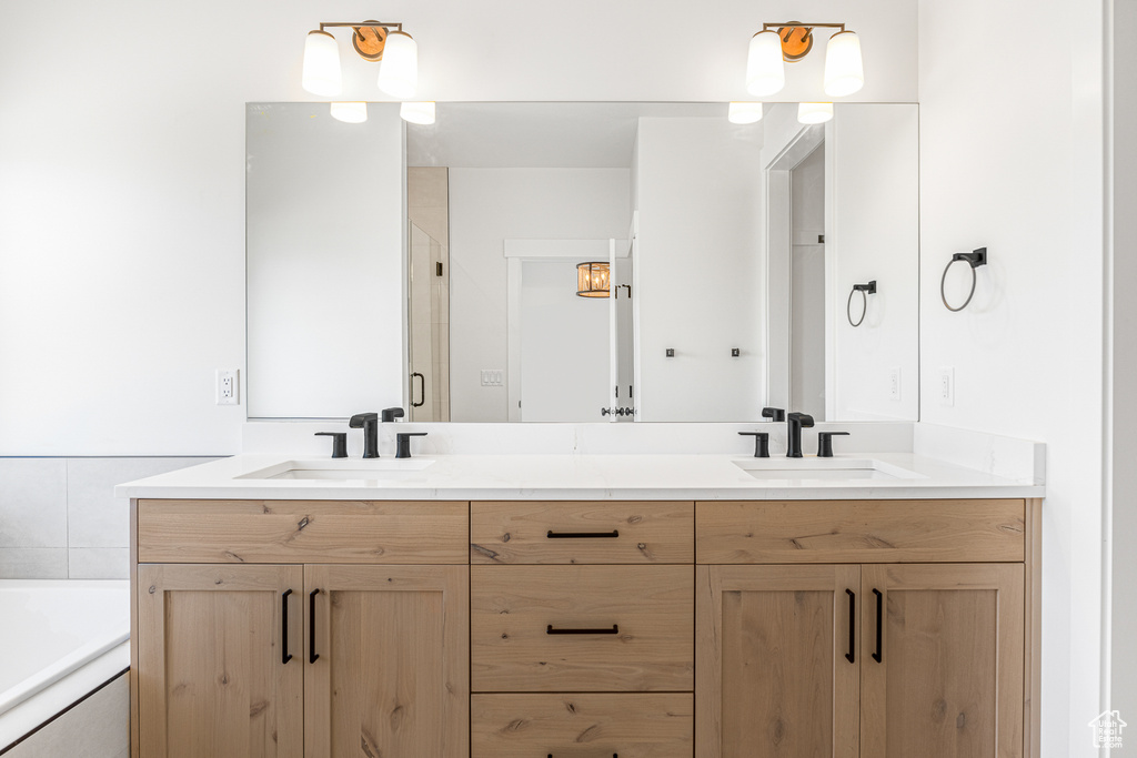 Bathroom featuring vanity and a tub to relax in