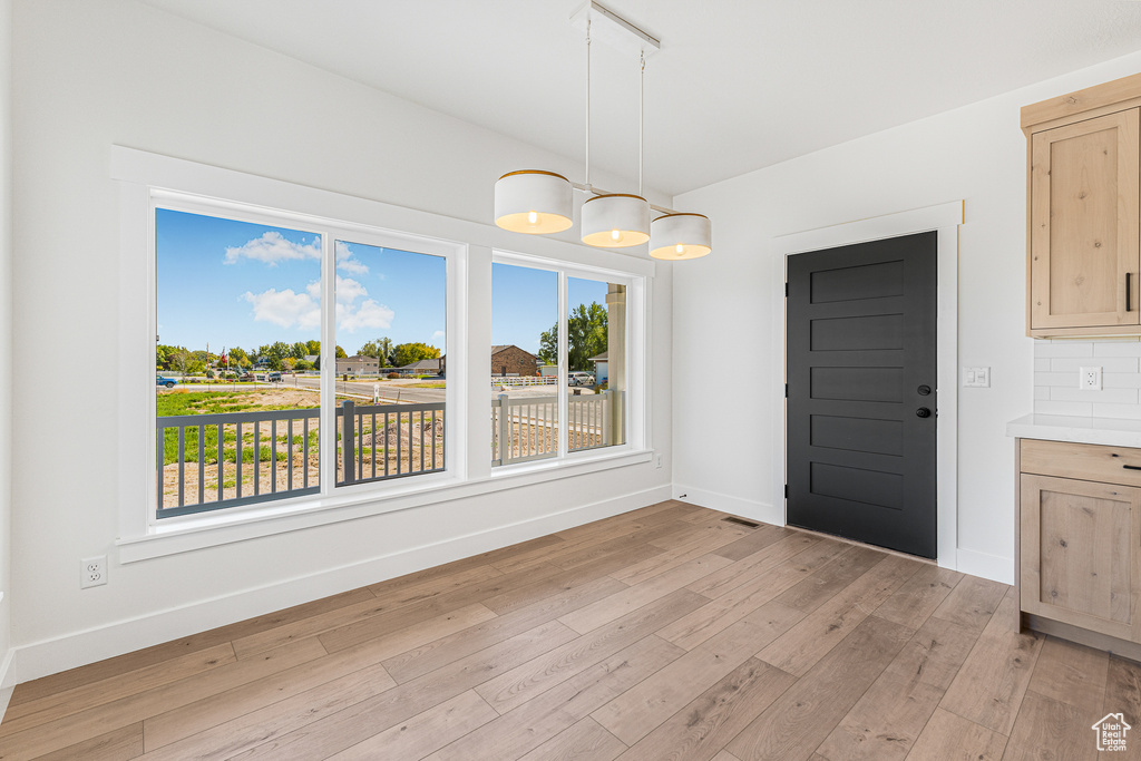 Unfurnished dining area featuring light hardwood / wood-style floors