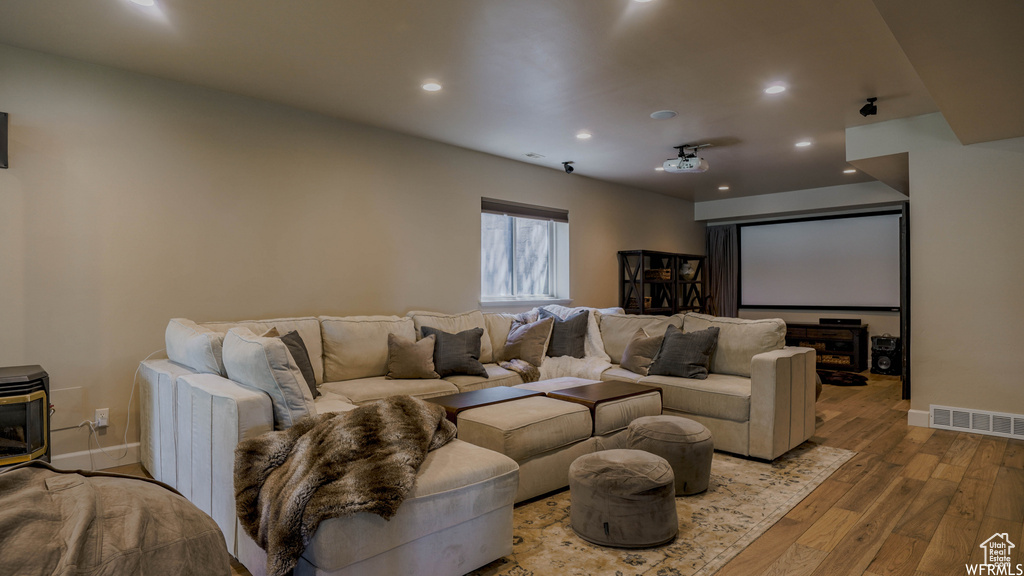 Cinema featuring light hardwood / wood-style floors