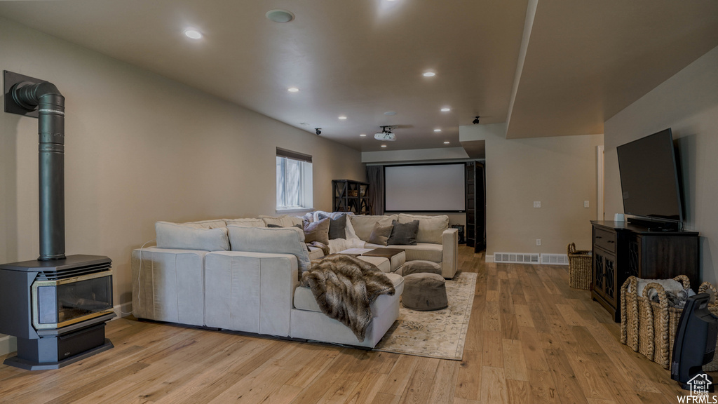 Living room featuring a wood stove and light wood-type flooring