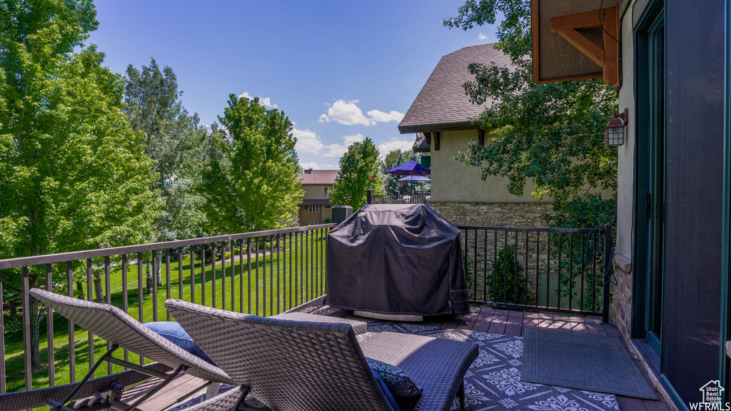 Deck featuring area for grilling and a yard