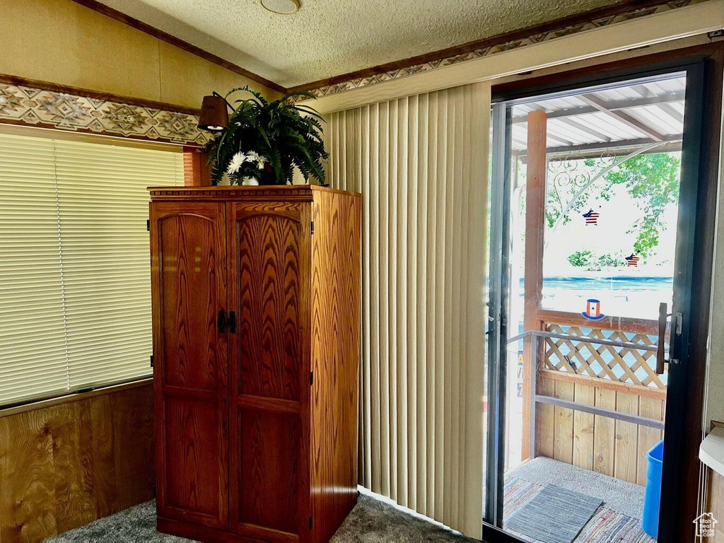 Entryway featuring a textured ceiling and carpet
