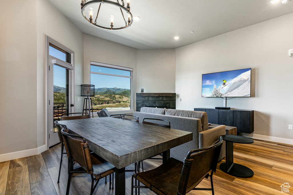 Dining area with a notable chandelier and dark hardwood / wood-style flooring