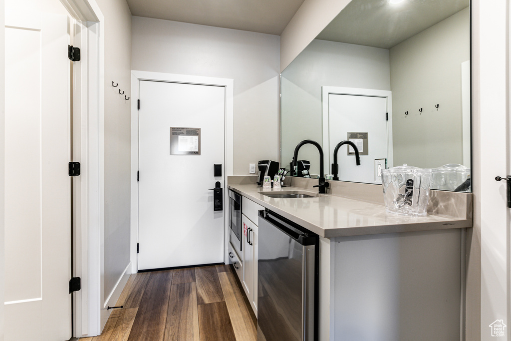 Bathroom with hardwood / wood-style flooring and vanity