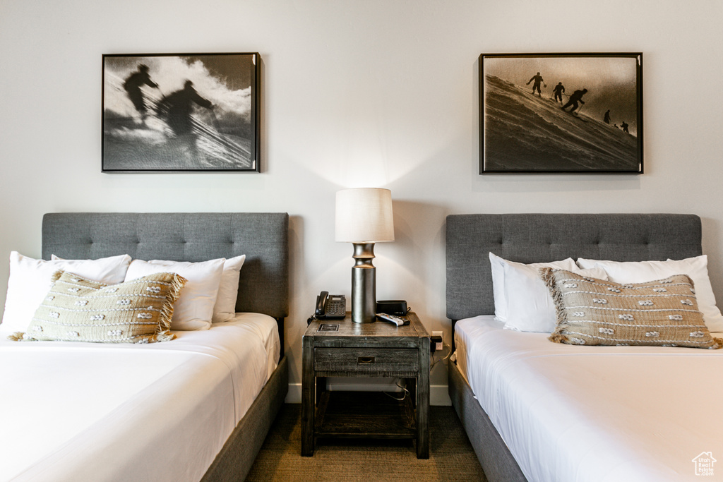 Bedroom featuring dark carpet