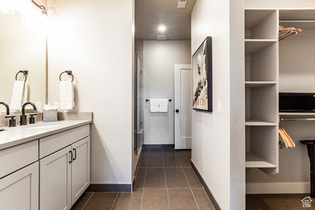 Bathroom featuring tile patterned floors and vanity