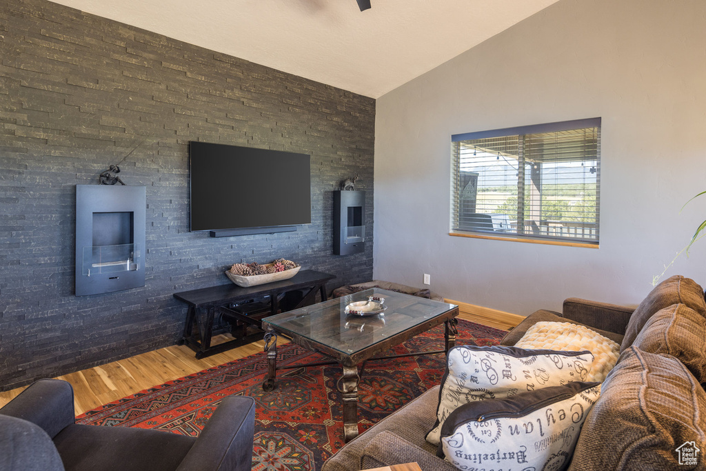 Living room featuring lofted ceiling and hardwood / wood-style floors