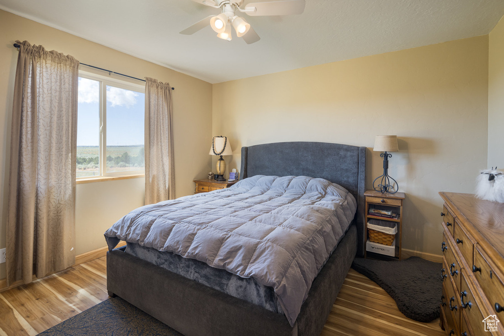 Bedroom with ceiling fan and light hardwood / wood-style floors